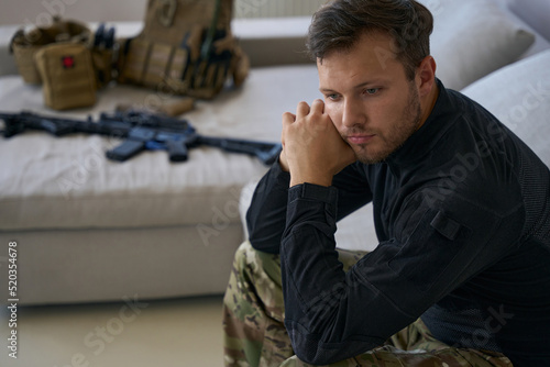 Stressed male soldier on leave at home from war