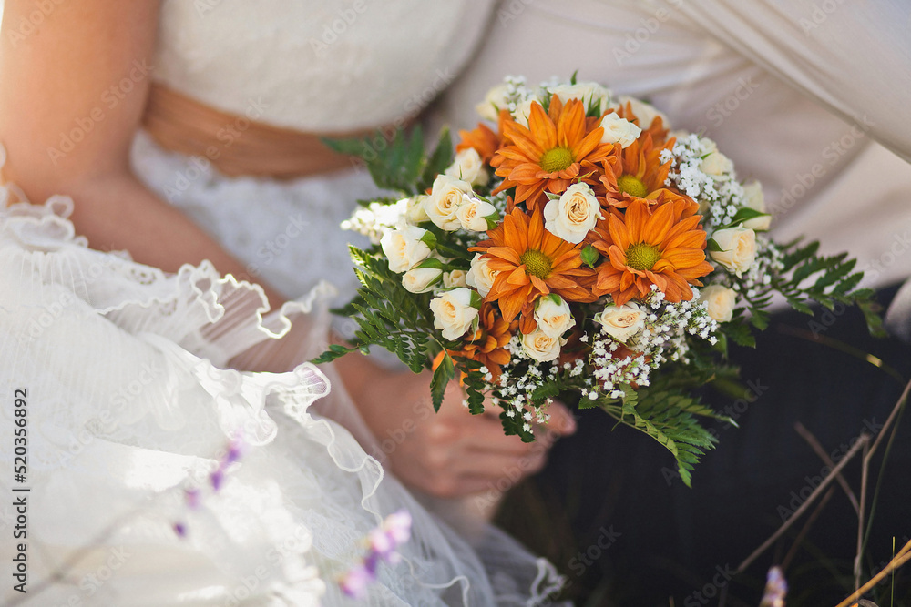 Bright wedding bouquet in hands of the bride Bright wedding bouquet in hands of the bride