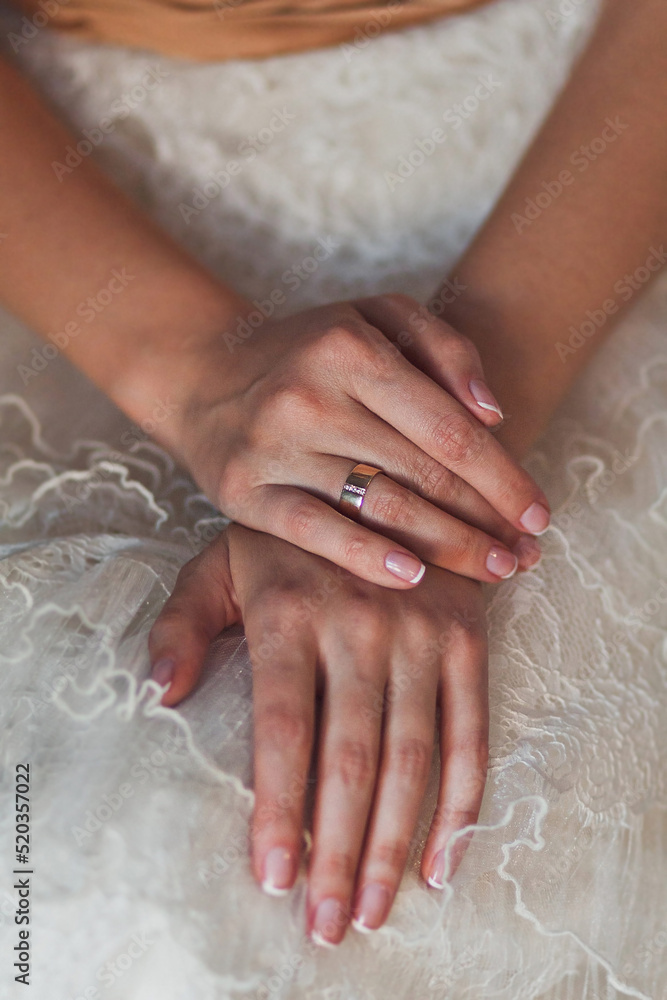 Engagement ring on bride's finger during wedding preparations Engagement ring on bride's finger during wedding preparations