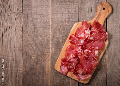 Italian slices of coppa, capocollo, capicollo or cured ham with rosemary. Raw food.  