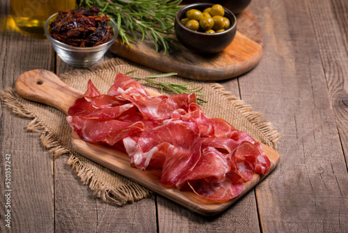 Bild auf Leinwand Italian slices of coppa, capocollo, capicollo or cured ham with rosemary