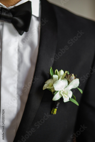 Elegant wedding boutonniere on the groom's suit