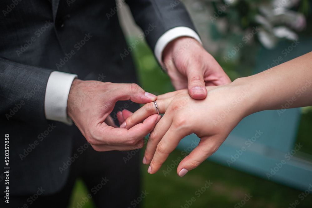 Bride and groom exchange rings at the wedding ceremony