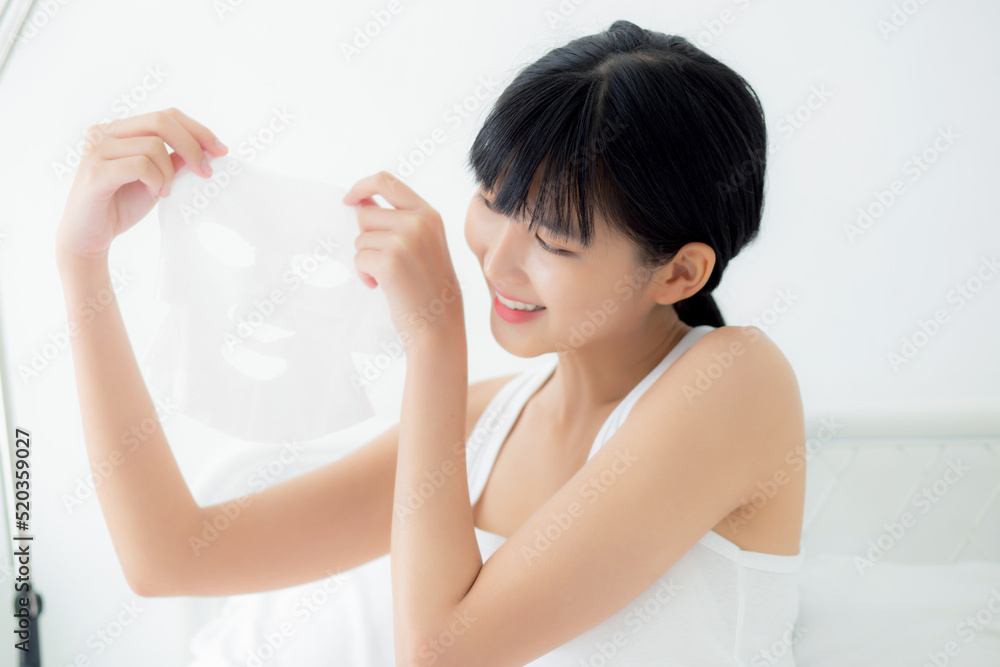 Beautiful young asian woman holding sheet facial mask for skin care and treatment, beauty girl showing sheet face mask with fun and relax at home, skincare and therapy for smooth, health and wellness. Beautiful young asian woman holding sheet facial mask for skin care and treatment, beauty girl showing sheet face mask with fun and relax at home, skincare and therapy for smooth, health and wellness.