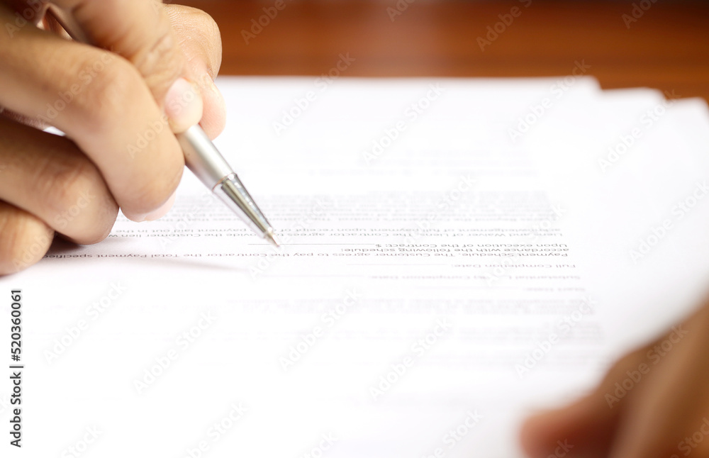 Signing a contract. business agreement. business people sign an official contract Signing a contract. business agreement. business people sign an official contract