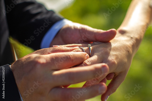 Bride and groom exchange rings at the wedding ceremony