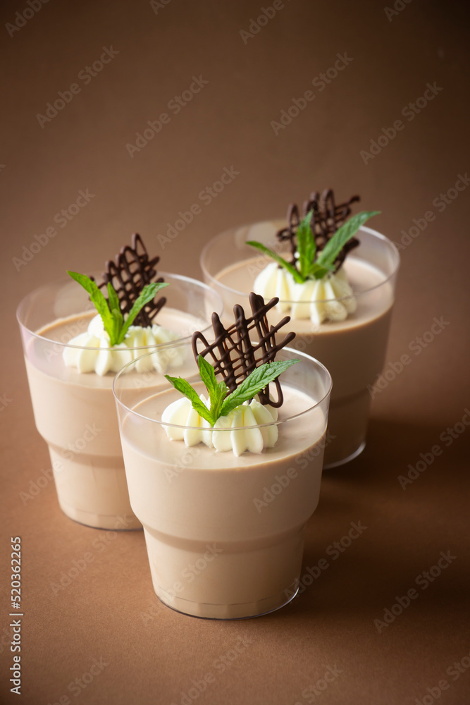 Chocolate mousse low calorie dessert on cups, whipped cream, mint