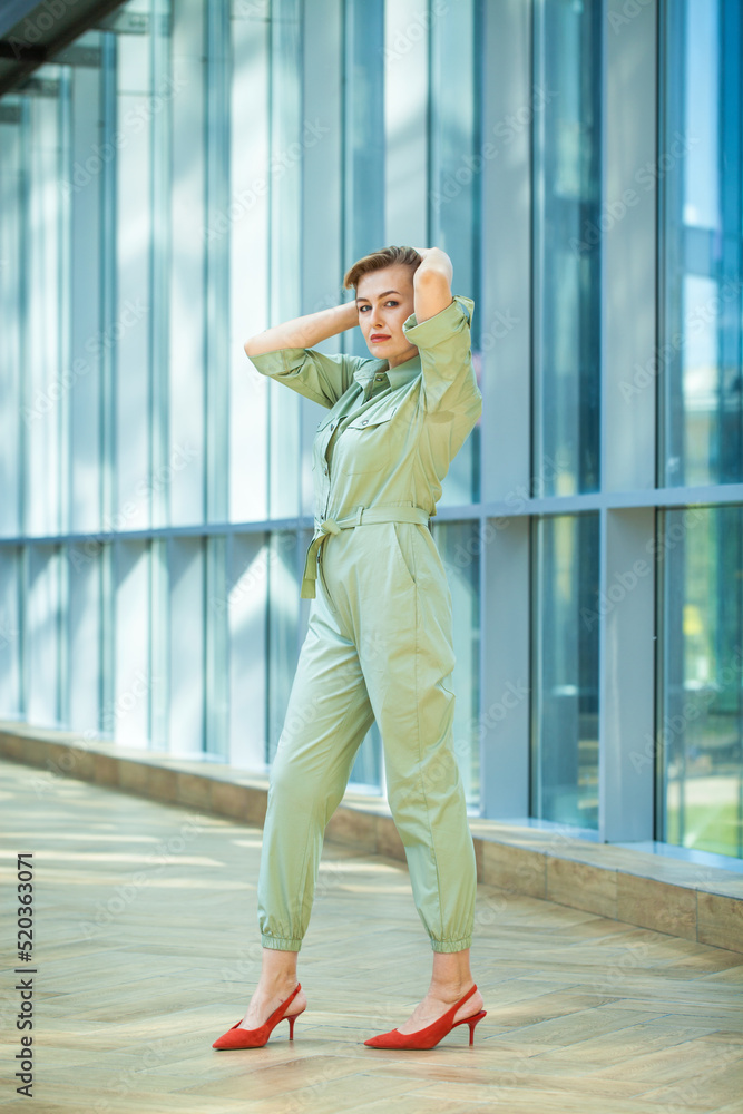 Blonde woman in a green jumpsuit Blonde woman in a green jumpsuit