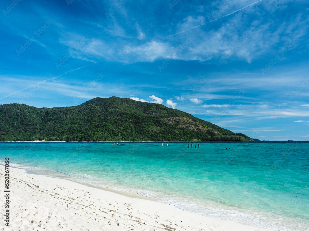 Scenic view of Sunrise Beach, Koh Lipe Island. White sand beach tropical island with crystal clear turquoise sea water against summer blue sky and Koh Adang Island background. Satun, Thailand.
