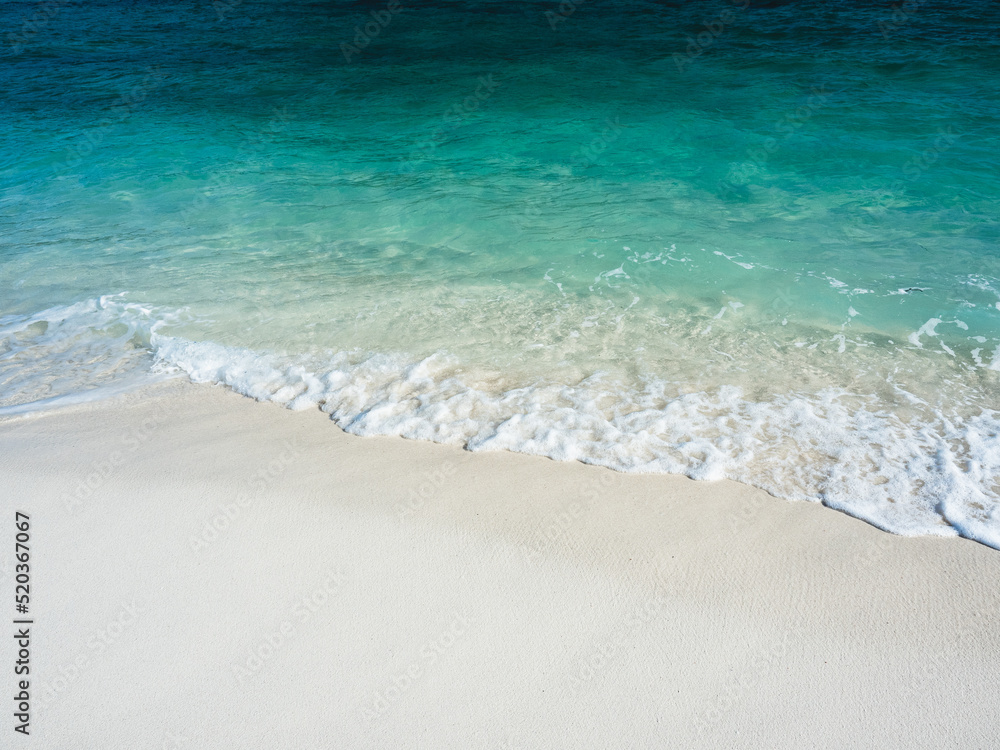 Scenic view of soft wave and white foam on white sand beach tropical island with crystal clear turquoise sea water. Sunrise Beach, Koh Lipe Island, Satun, Thailand. Minimal background.