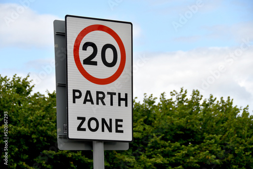 Bilingual road sign showing a 20 mph speed limit at the approach to a village in Wales photo