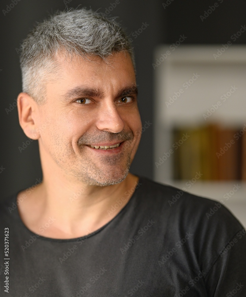 Fototapeta premium Happy handsome middle aged man with stubble smiling