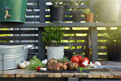 Fototapeta Naklejka Na Ścianę i Meble -  Marinated beef steak on wooden table top. Healthy food concept. Beef cut and spices for cooking bbq sauce outdoors, garden kitchen