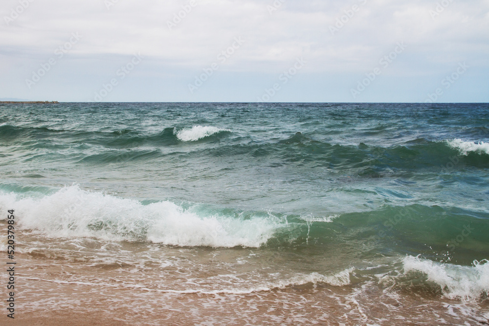Seascape. Sea coast. Waves. Sea water. Horizon. Sky. Spain. Mediterranean Sea.