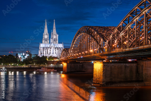 Cologne skyline at night with view of Cologne Cathedral and Hohenzollern Bridge, North Rhine-Westphalia, Germany photo