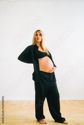 Portrait of attractive woman enjoying pregnancy, smile, relaxing, hugging belly, isolated on white background