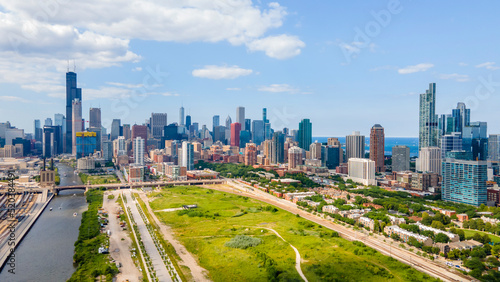 establishing aerial drone footage of  Chicago downtown near the park. the skyscrapers can be seen in the background as the clouds and sky are clear beautiful 