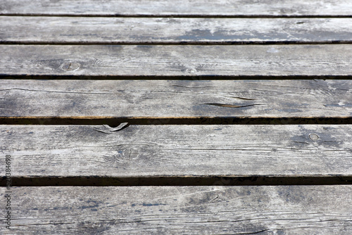 Old wooden boards, flooring texture. Grey panels with gaps and weathered paint for background
