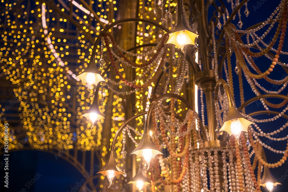 Hanging golden lamp with glitter pearl decorated with light bokeh
