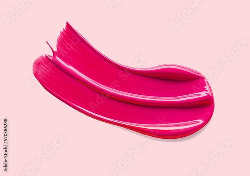 Lip gloss swatch or shimmering cosmetic gel mask sample on pink background