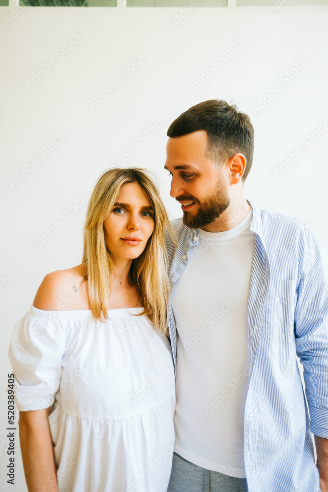 Portrait of future mother and father. Husband hugs pregnant wife. Happy family resting at home Portrait of future mother and father. Husband hugs pregnant wife. Happy family resting at home