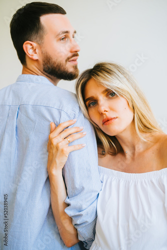 Portrait of future mother and father. Husband hugs pregnant wife. Happy family resting at home