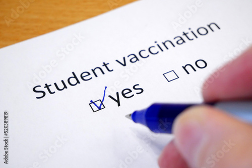 Hand daw in the questionnaire. A closeup of female hand answering about a student vaccination question marking in a checkbox