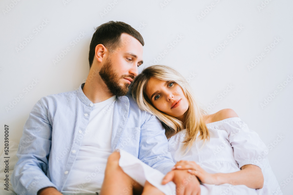 Portrait of future mother and father, husband hug pregnant wife. Happy family resting at home Portrait of future mother and father, husband hug pregnant wife. Happy family resting at home