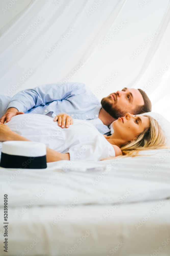 Future mother and father clasped pregnant big tummy. husband hugs pregnant wife. Happy family resting at home Future mother and father clasped pregnant big tummy. husband hugs pregnant wife. Happy family resting at home