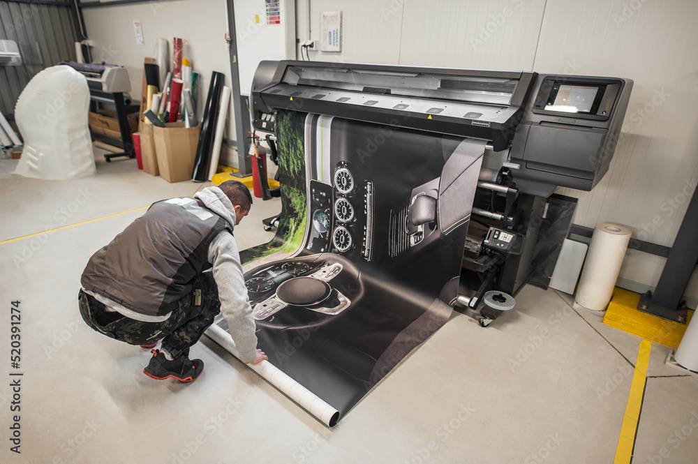 Technician operator works on large premium industrial printer plotter machine - obrazy, fototapety, plakaty 