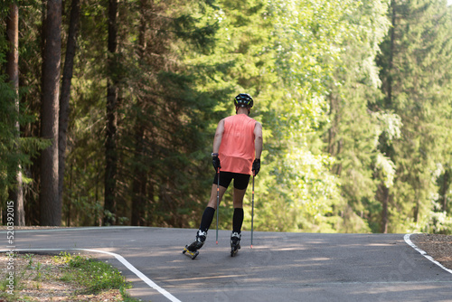 Man ride roller skis in the autumn Park.