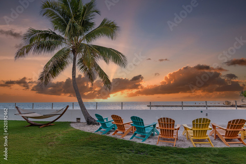 Fototapeta Naklejka Na Ścianę i Meble -  Vacation holidays background wallpaper - colorful beach lounge chairs in a resort. 