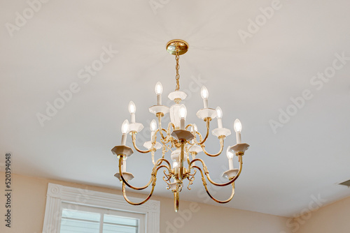 Obraz na plátně brass gold chandelier on the ceiling historic design vintage antique light fixtu