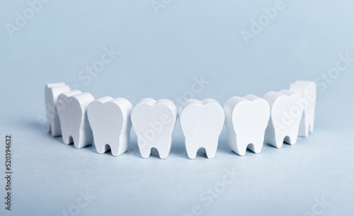 Toy teeth row on blue background. High quality photo