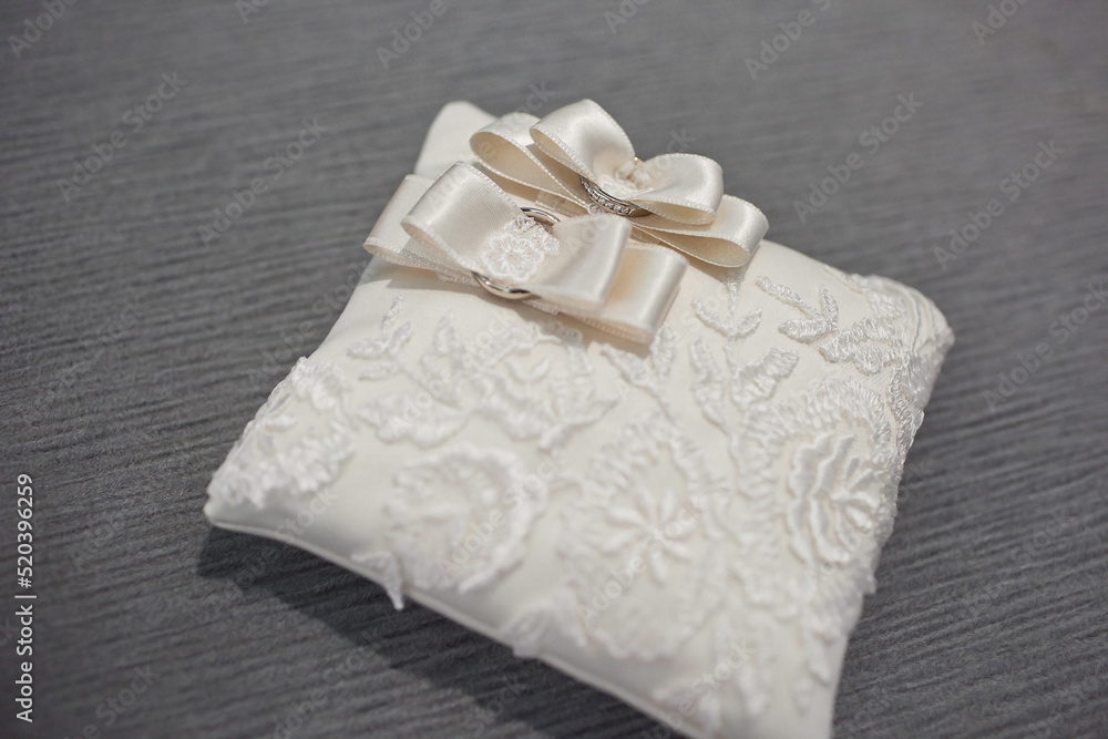 Two wedding rings on a lace pillow Two wedding rings on a lace pillow