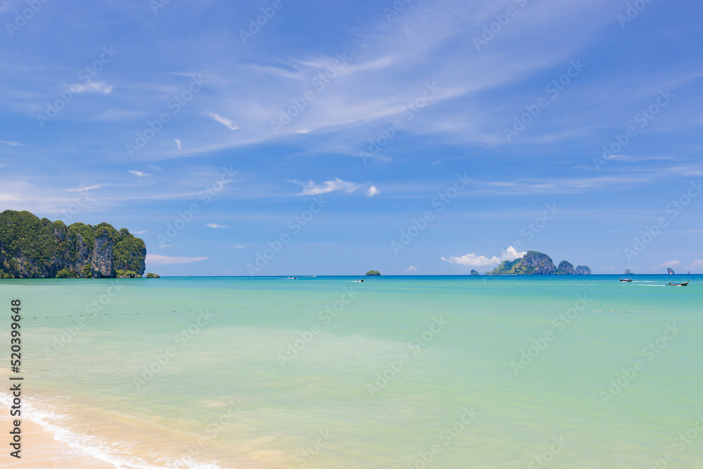Blue sky and sea with tourist boat at Ao Nang or Nopparat Thara Beach, a destination of tourist in Krabi, Southern of Thailand