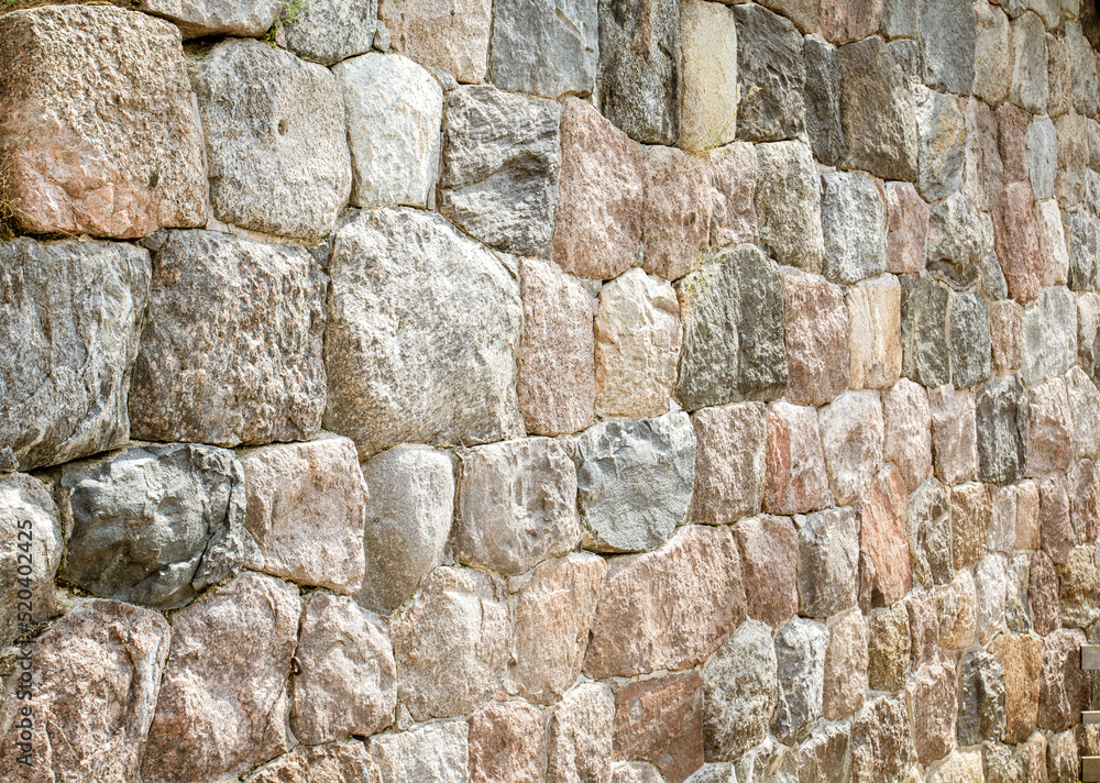 fortress wall made of natural boulders close-up fortress wall made of natural boulders close-up
