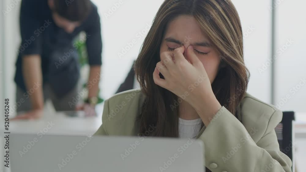 Young asian business woman working at office. Female employee overworked by pc feel fatigue suffer from eye strain. Young asian business woman working at office. Female employee overworked by pc feel fatigue suffer from eye strain.
