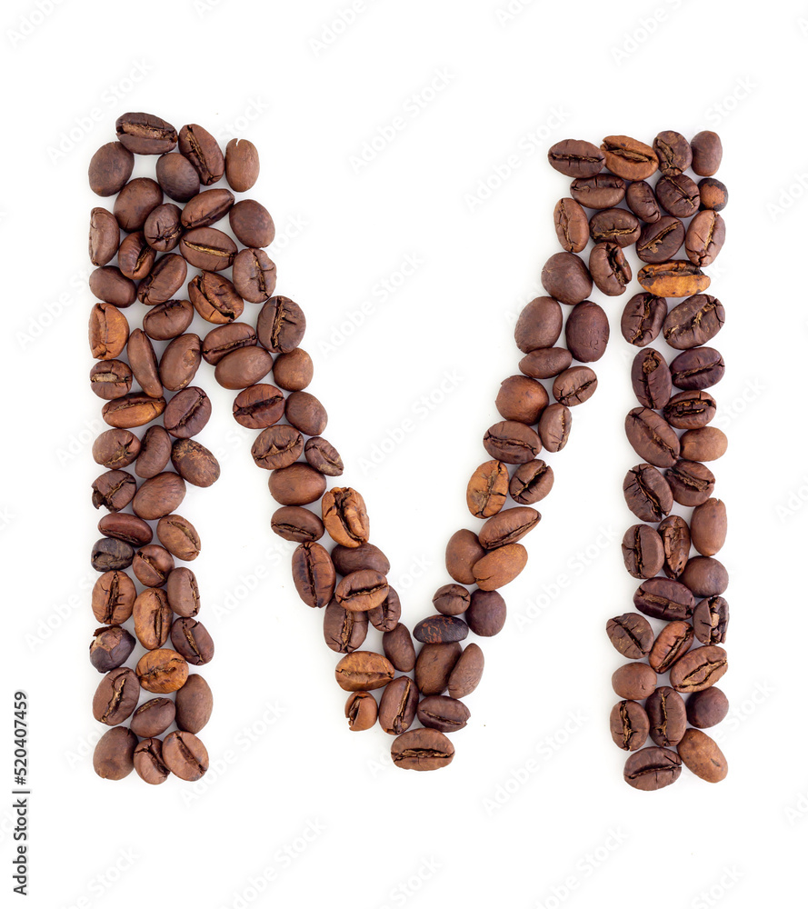Capital letter M made from coffee beans. Coffee font. Alphabet made from coffee beans. White background. Roasted coffee beans. Capital letter M made from coffee beans. Coffee font. Alphabet made from coffee beans. White background. Roasted coffee beans.