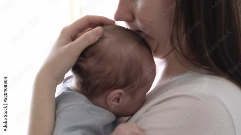 Mommy tries to calm the crying baby, shakes him in her arms, Dissatisfied, crying, upset, sad Newborn baby boy on mother hands at home Mommy tries to calm the crying baby, shakes him in her arms, Dissatisfied, crying, upset, sad Newborn baby boy on mother hands at home