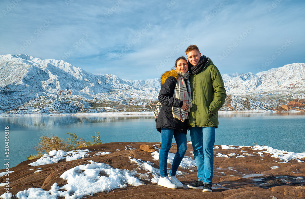 happy young couple on the background of snowy mountains