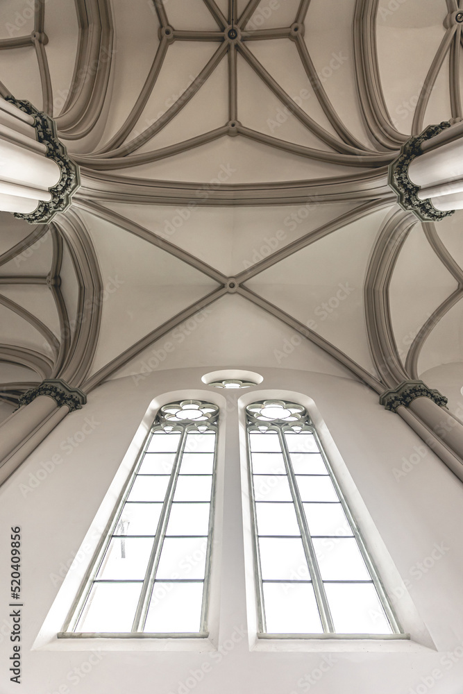 Fototapeta premium Bright interior of the church with stained-glass windows, view from below.