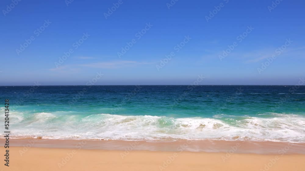 Static shot of ocean waves foaming on golden sand beach. Beautiful nature background. Coastline. Summer vacation at sea. High quality 4k slow motion footage. Los Arcos, Cabo san Lucas, Mexico. Static shot of ocean waves foaming on golden sand beach. Beautiful nature background. Coastline. Summer vacation at sea. High quality 4k slow motion footage. Los Arcos, Cabo san Lucas, Mexico.