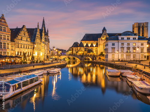 Historic medieval building illuminated at night on Leie river in Ghent  Belgium