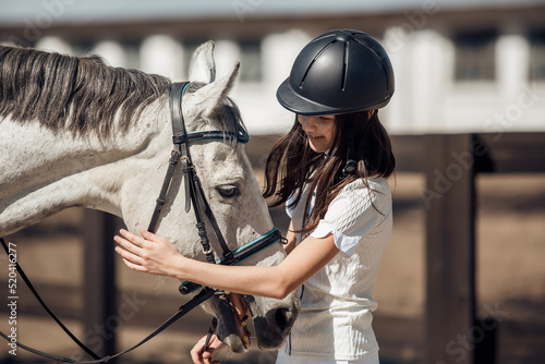 Photographie Young teenage girl equestrian having fun with her favorite horse