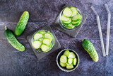 Refreshing water with cucumber in glasses on the table. Homemade antioxidant drinks. Top view