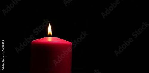 Red candle on black
