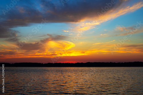 Beautiful sunset on the river with dramatic clouds © Igor Nikushin