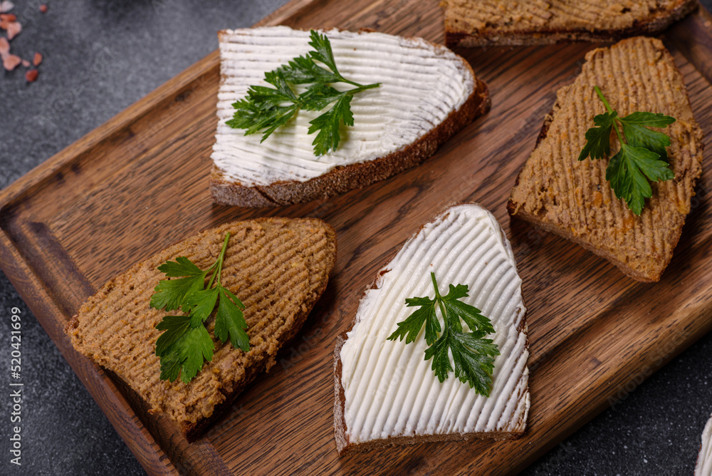 Appetizer, baguette with liver paste and herbs, closeup. Homemade breakfast Appetizer, baguette with liver paste and herbs, closeup. Homemade breakfast