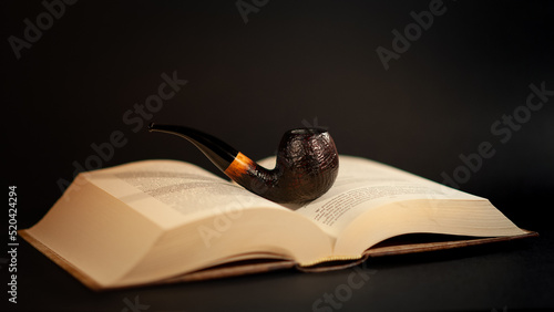 Tobacco pipe on the book photo